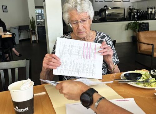 Judy Young looks over the National Senior Games swim schedule.